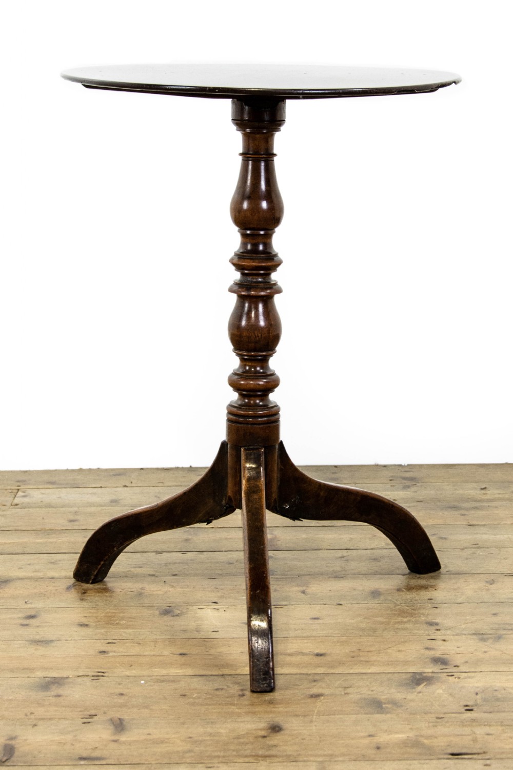 An antique mahogany side table featuring an oval top supported by a turned central pedestal and three curved tripod legs. View VI