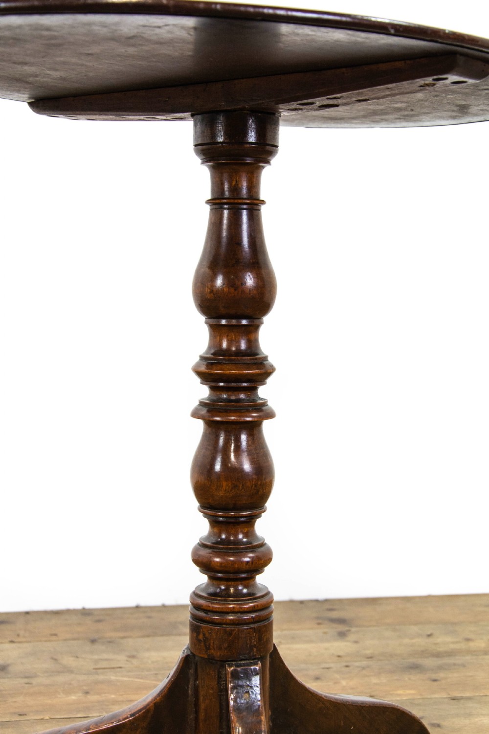 An antique mahogany side table featuring an oval top supported by a turned central pedestal and three curved tripod legs. View VIII