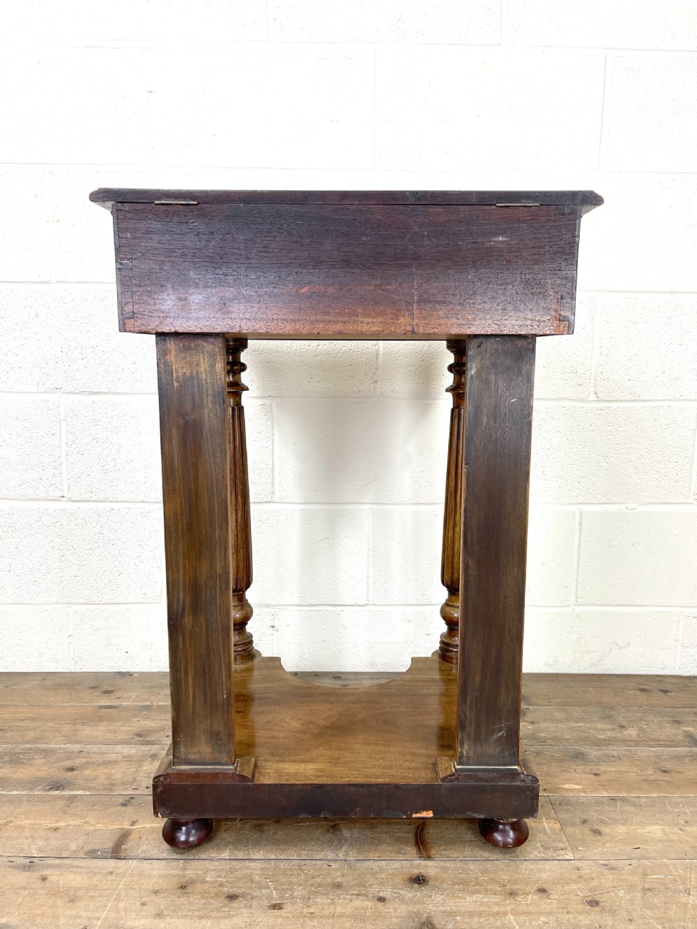 A Victorian mahogany Davenport writing desk featuring a slanted red leather insert, turned column supports, and a plinth base. View IX
