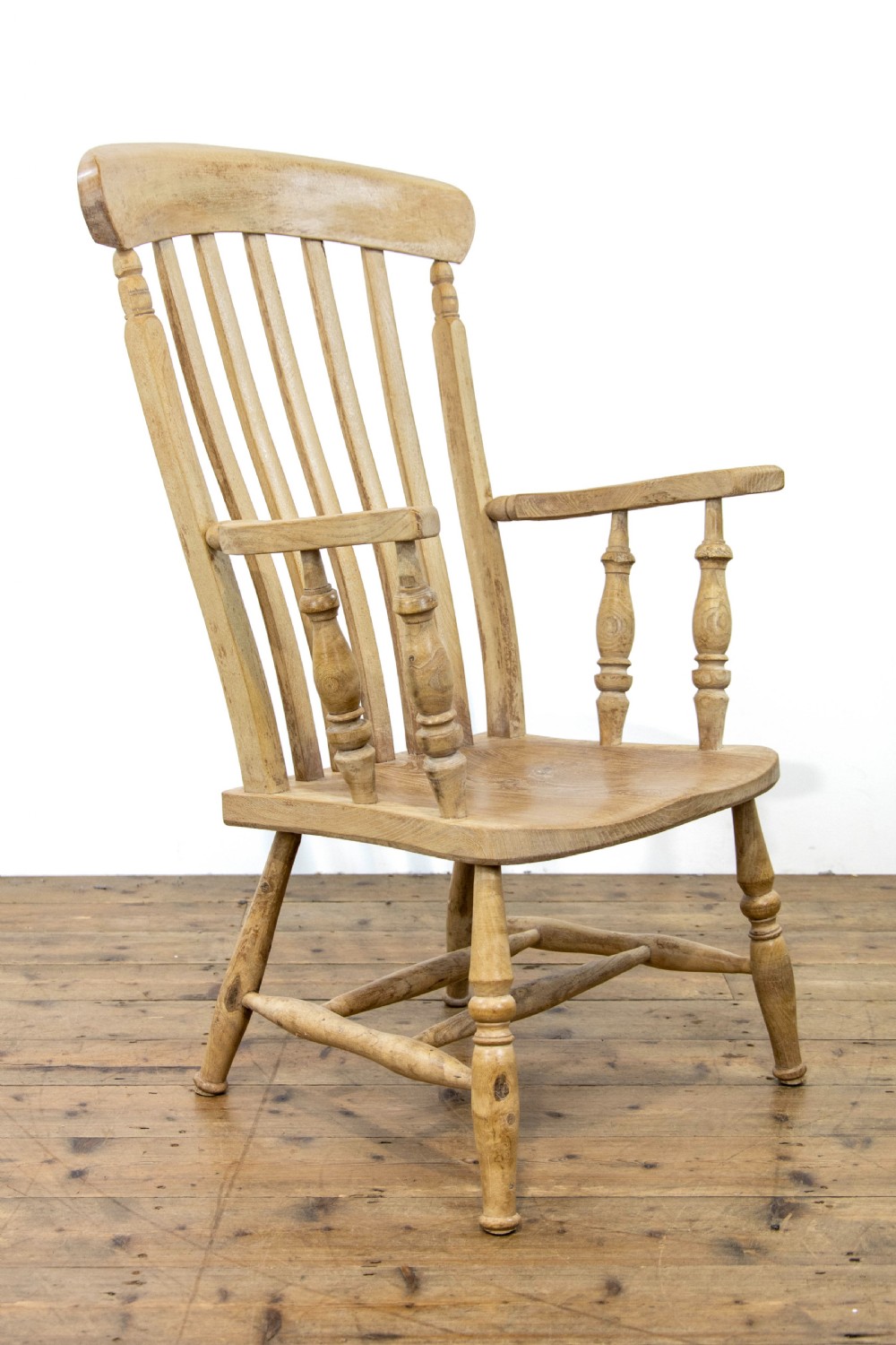 A light ash and elm antique Windsor armchair featuring a spindle backrest, turned legs, and a solid shaped wooden seat. View II