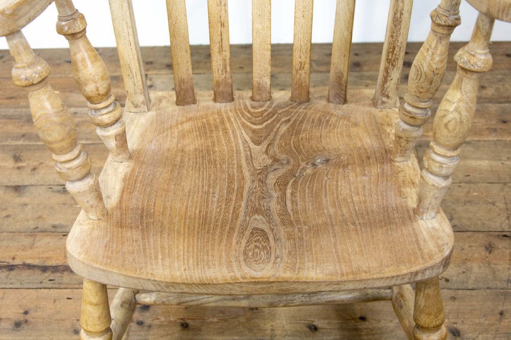 A light ash and elm antique Windsor armchair featuring a spindle backrest, turned legs, and a solid shaped wooden seat. View V