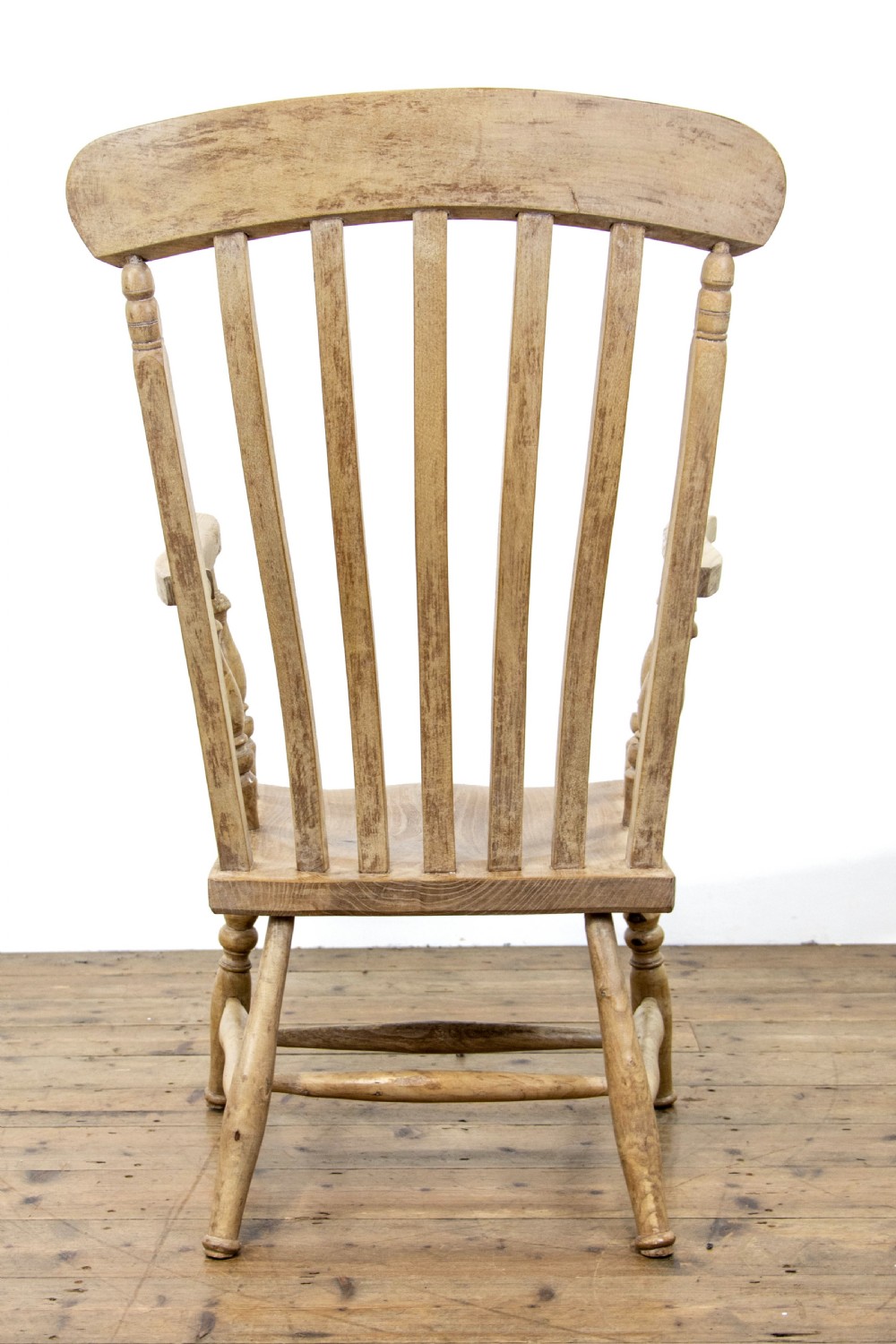 A light ash and elm antique Windsor armchair featuring a spindle backrest, turned legs, and a solid shaped wooden seat. View VII