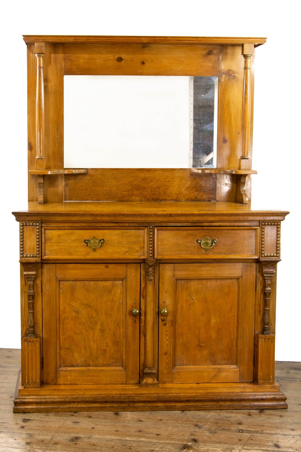 A light oak and pine sideboard featuring a raised mirror back with turned columns, two upper drawers, and a two-door lower cupboard. View II