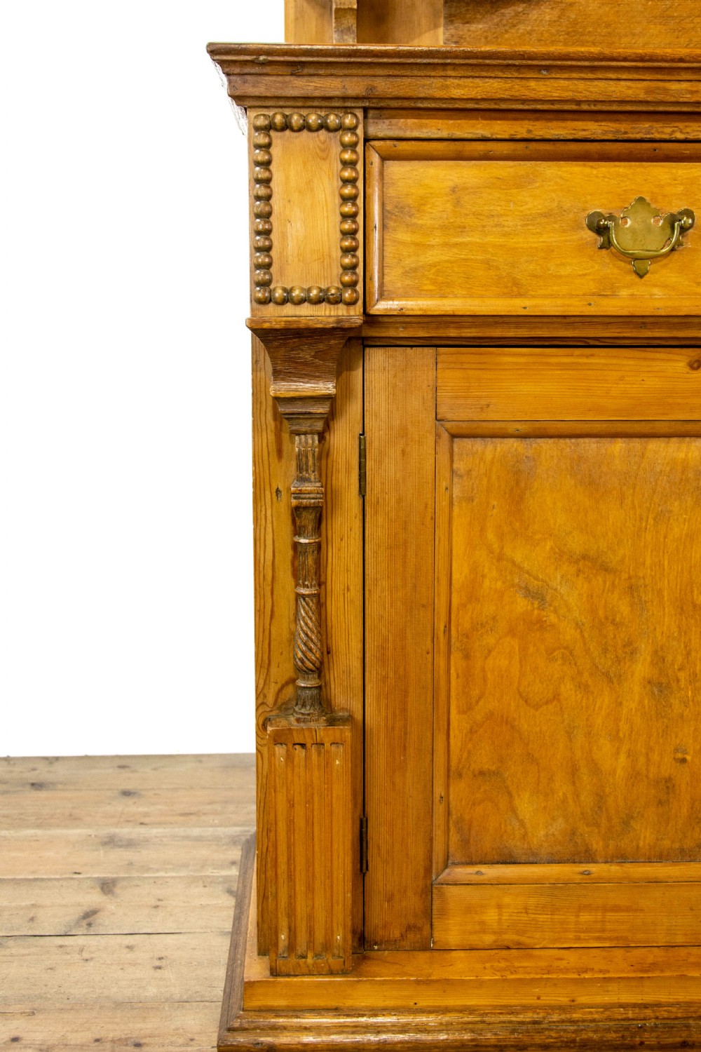 A light oak and pine sideboard featuring a raised mirror back with turned columns, two upper drawers, and a two-door lower cupboard. View IV