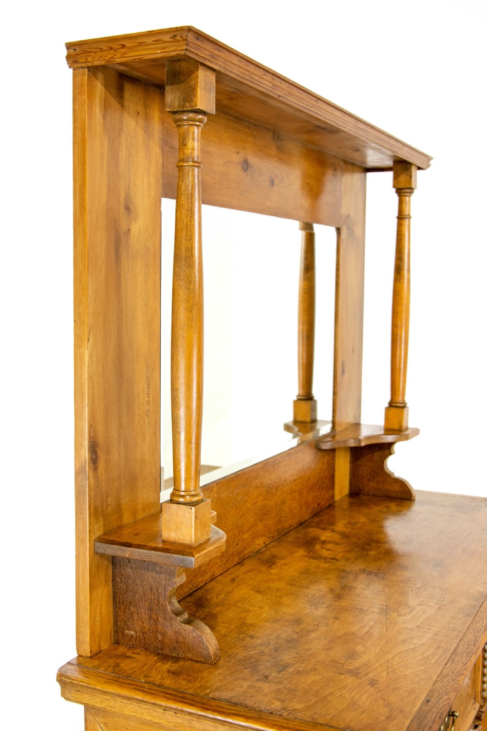 A light oak and pine sideboard featuring a raised mirror back with turned columns, two upper drawers, and a two-door lower cupboard. View VI