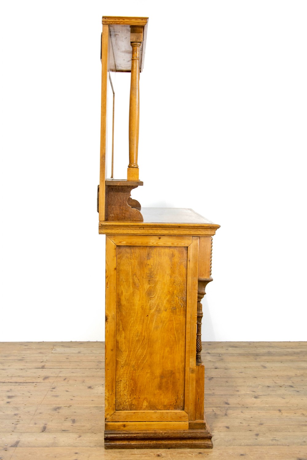 A light oak and pine sideboard featuring a raised mirror back with turned columns, two upper drawers, and a two-door lower cupboard. View IX