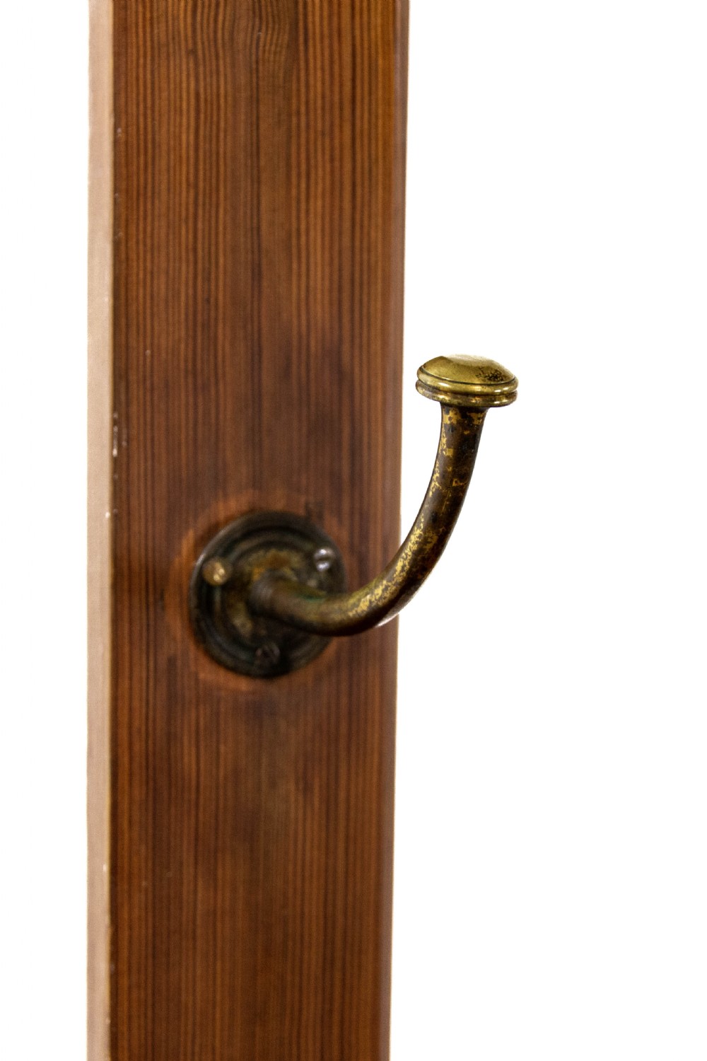 A tall Victorian pitch pine hall stand featuring a central mirror, brass coat hooks, a small drawer unit, and integrated umbrella racks with drip trays. View VI
