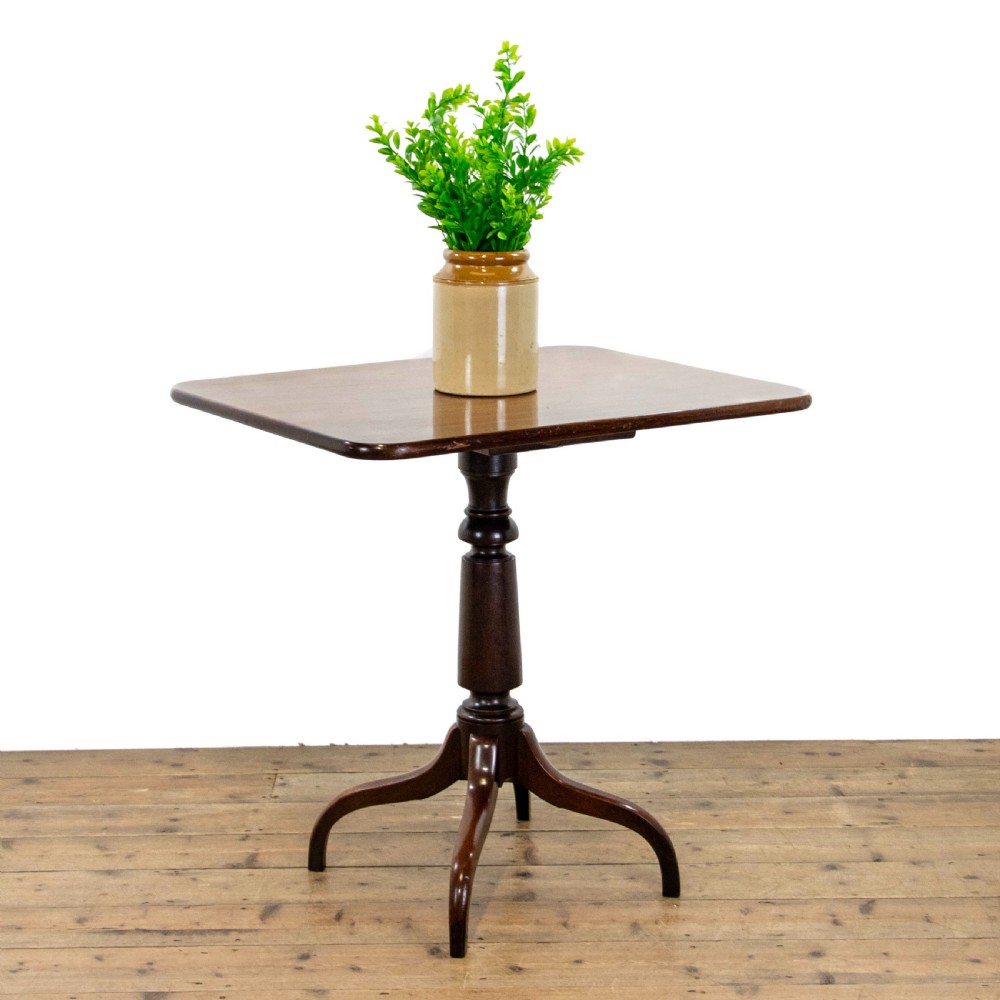 A 19th-century dark mahogany side table featuring a rounded rectangular top supported by a central turned pedestal stem and three down-curved legs. View II
