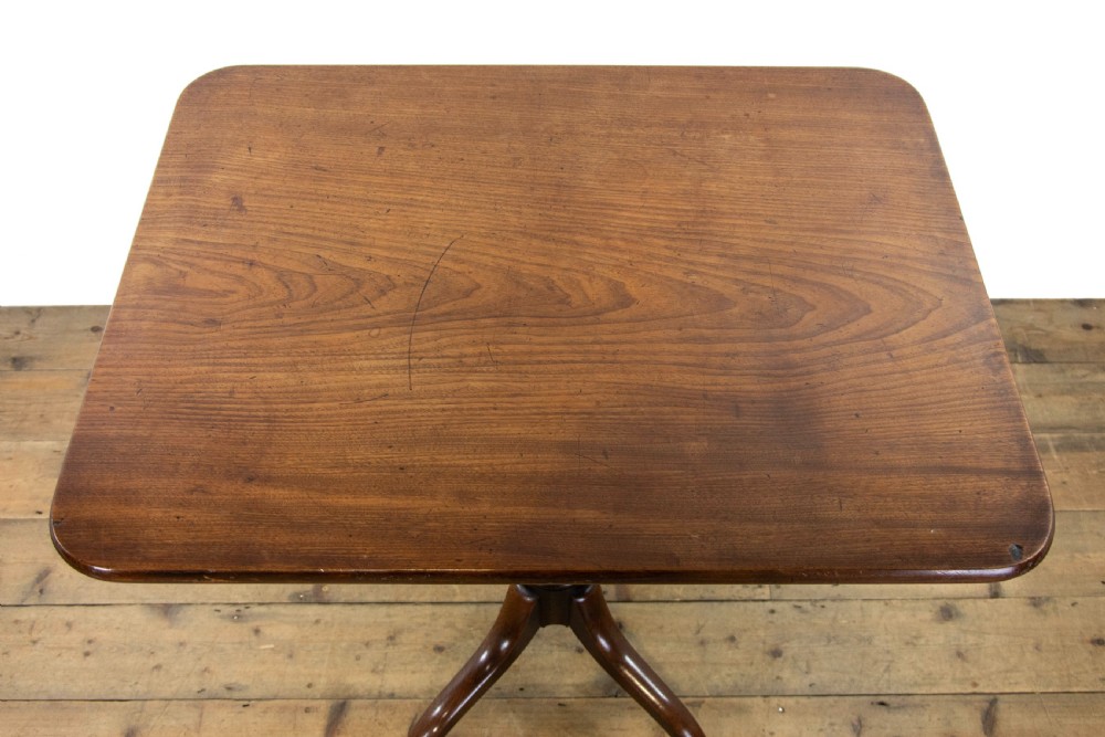 A 19th-century dark mahogany side table featuring a rounded rectangular top supported by a central turned pedestal stem and three down-curved legs. View IV