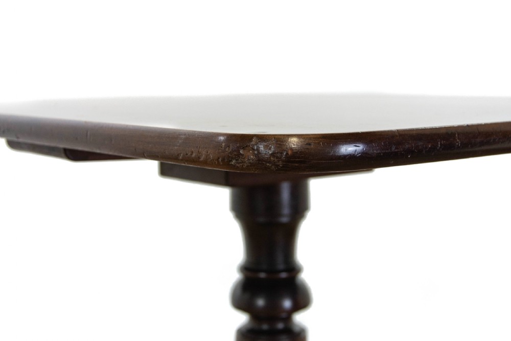 A 19th-century dark mahogany side table featuring a rounded rectangular top supported by a central turned pedestal stem and three down-curved legs. View V