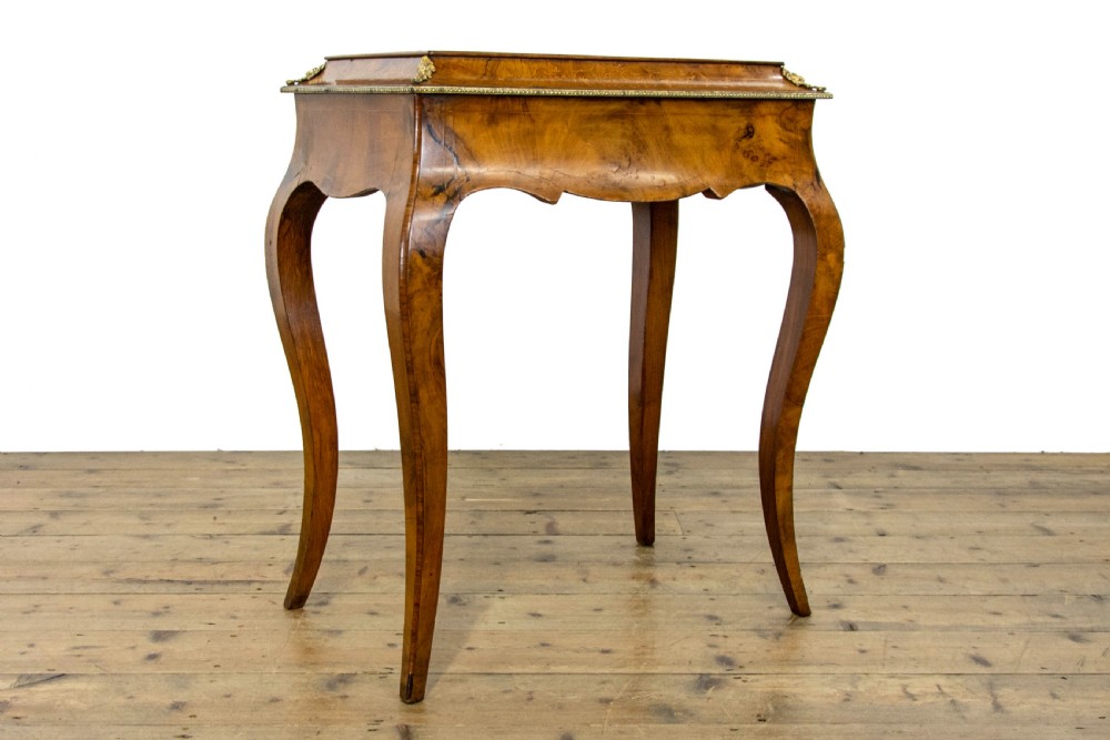 An antique French Rococo style burr walnut jardiniere table with decorative marquetry inlay on the lid, brass mounts, and slender cabriole legs. View II