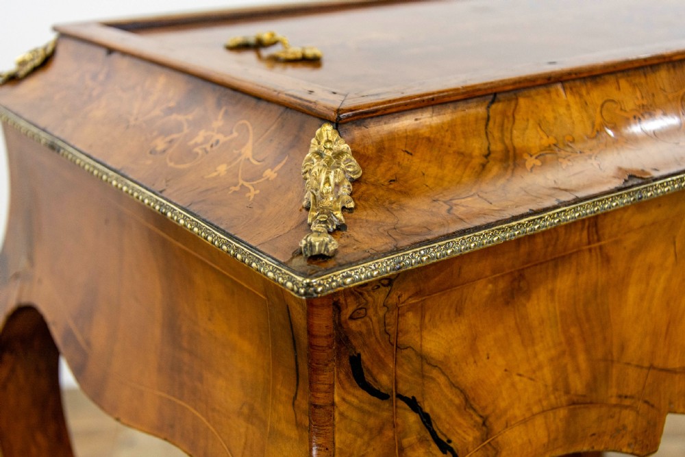 An antique French Rococo style burr walnut jardiniere table with decorative marquetry inlay on the lid, brass mounts, and slender cabriole legs. View III