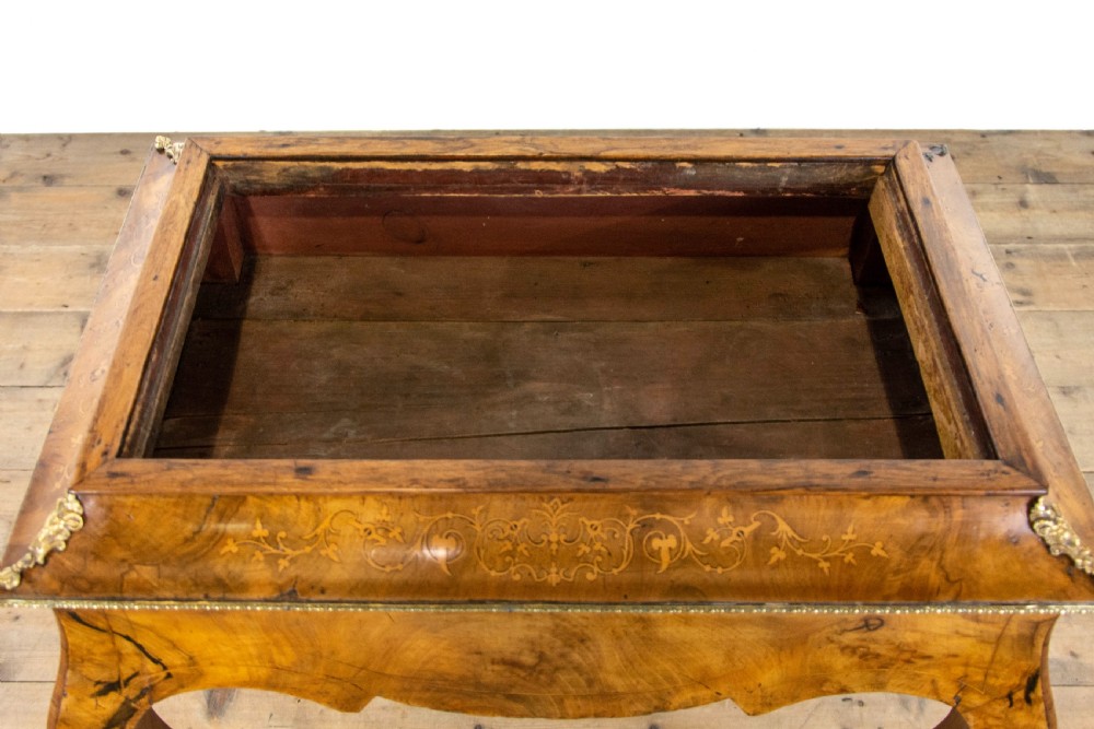 An antique French Rococo style burr walnut jardiniere table with decorative marquetry inlay on the lid, brass mounts, and slender cabriole legs. View X
