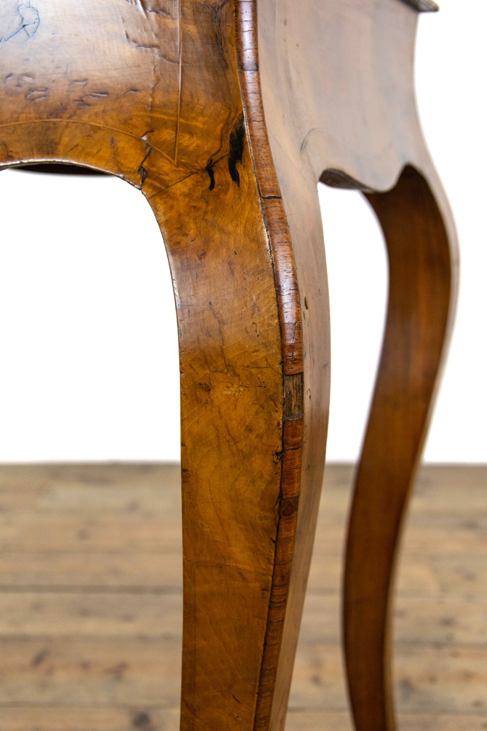 An antique French Rococo style burr walnut jardiniere table with decorative marquetry inlay on the lid, brass mounts, and slender cabriole legs. View XI