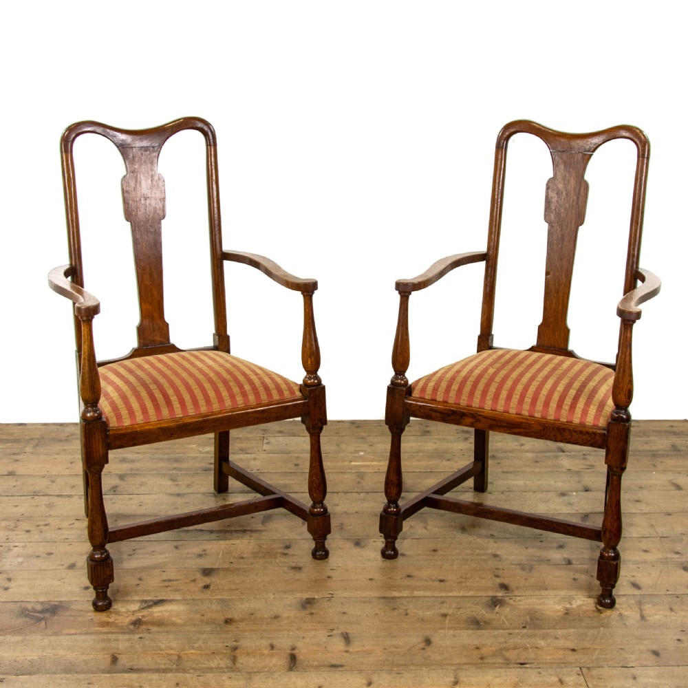 A pair of antique oak armchairs featuring shaped splat backs, curved armrests, turned legs, and red striped upholstered seats. View II