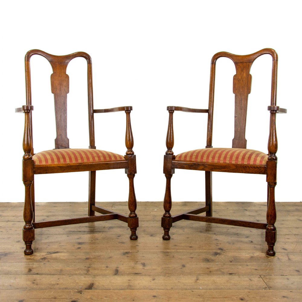 A pair of antique oak armchairs featuring shaped splat backs, curved armrests, turned legs, and red striped upholstered seats. View III