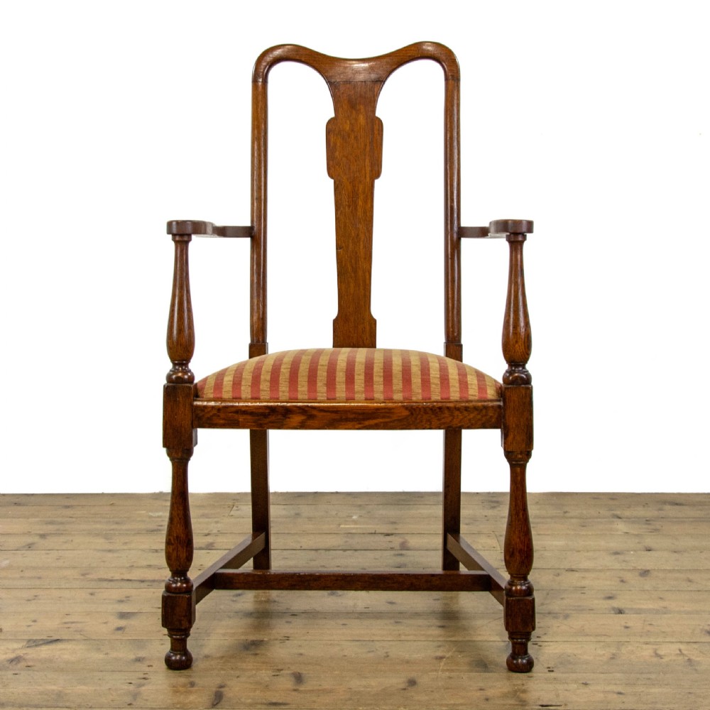 A pair of antique oak armchairs featuring shaped splat backs, curved armrests, turned legs, and red striped upholstered seats. View V