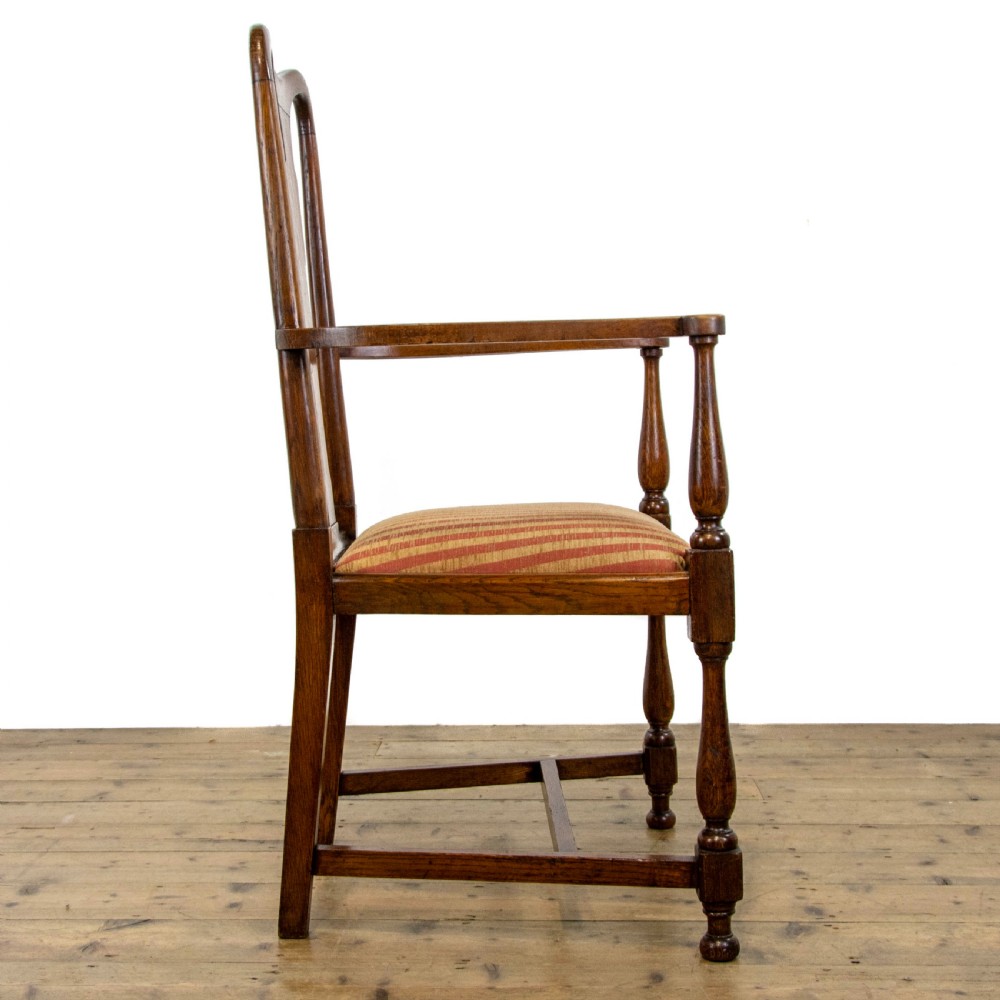 A pair of antique oak armchairs featuring shaped splat backs, curved armrests, turned legs, and red striped upholstered seats. View VII