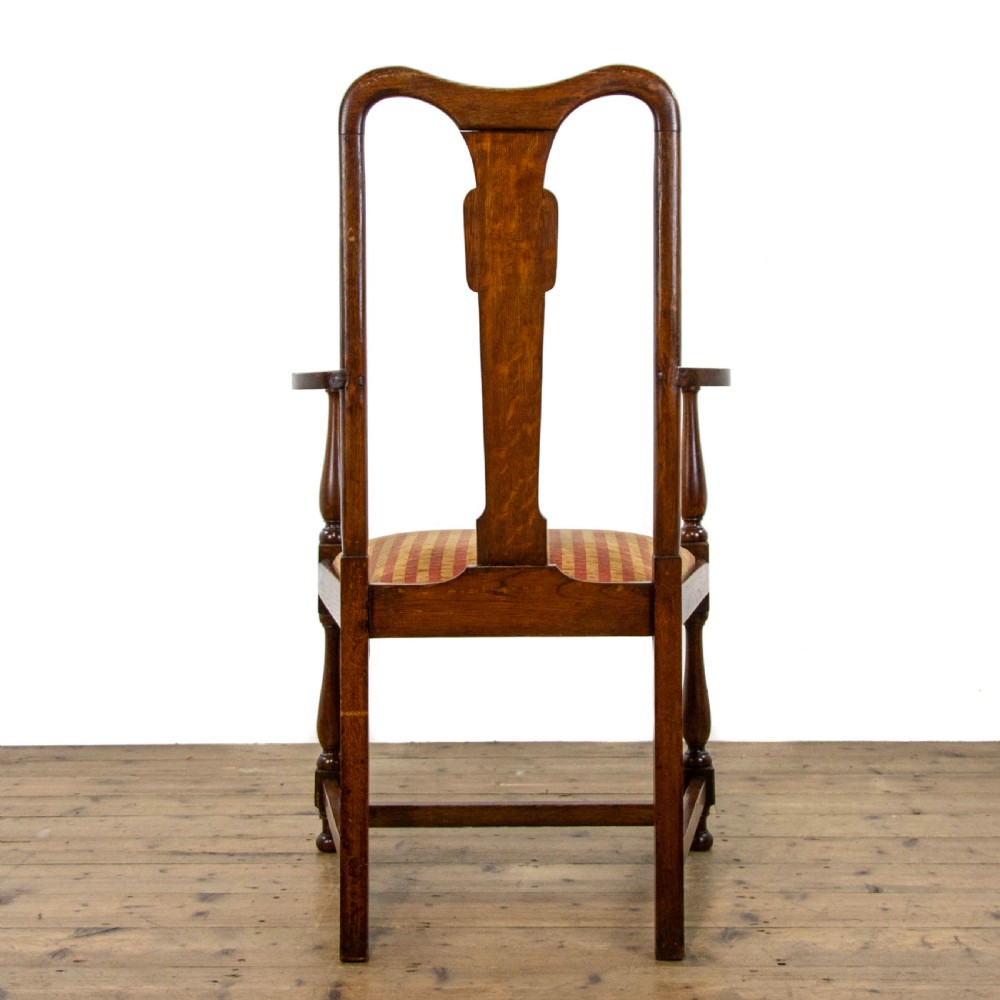 A pair of antique oak armchairs featuring shaped splat backs, curved armrests, turned legs, and red striped upholstered seats. View VIII