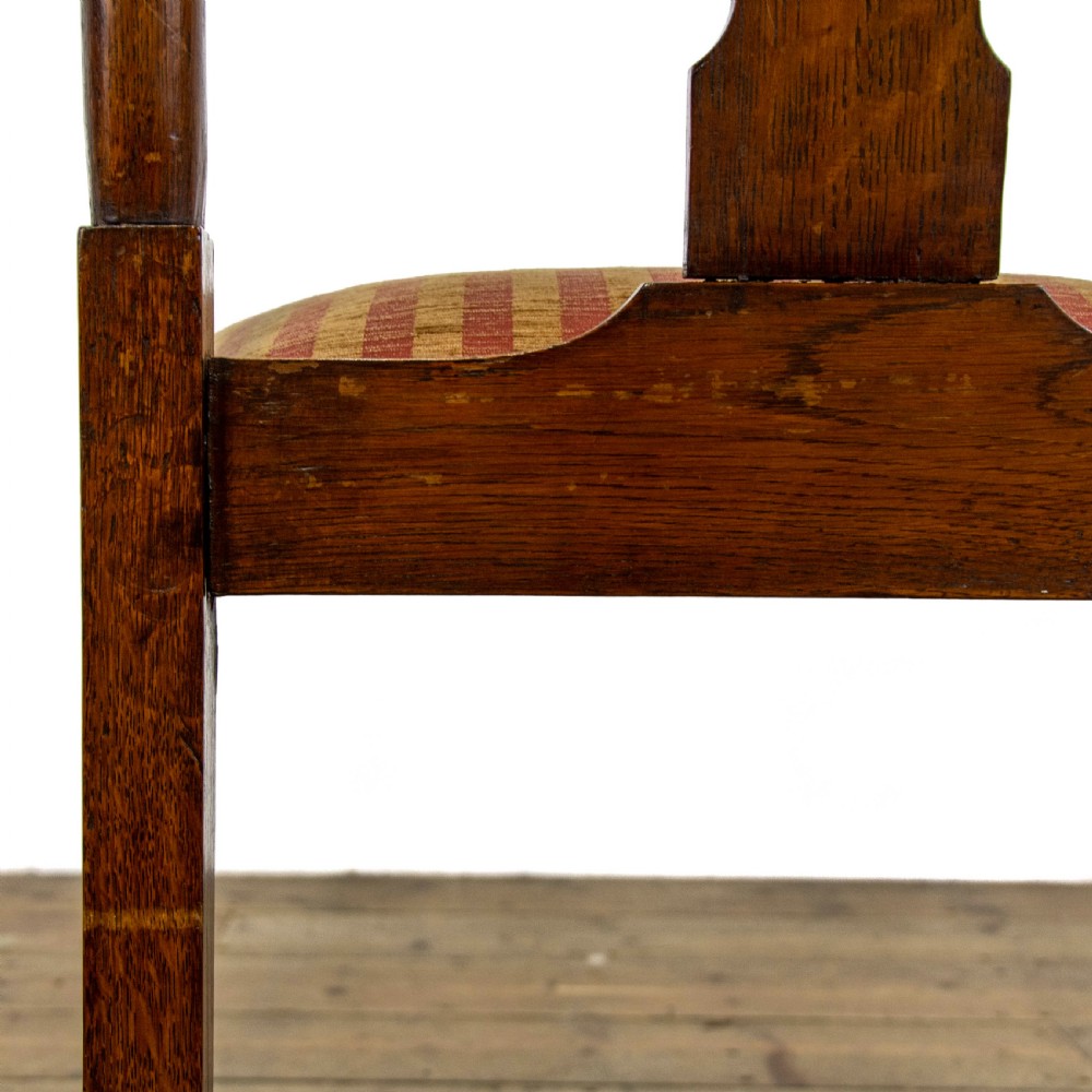 A pair of antique oak armchairs featuring shaped splat backs, curved armrests, turned legs, and red striped upholstered seats. View IX