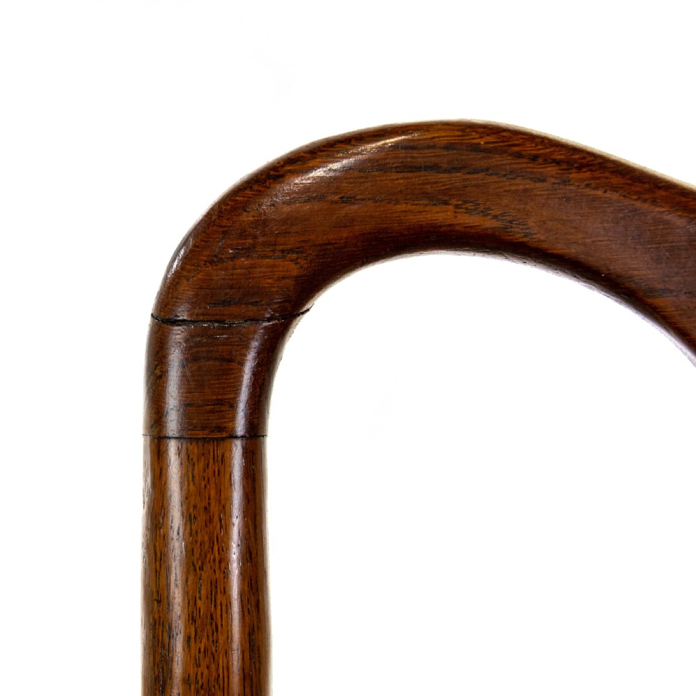 A pair of antique oak armchairs featuring shaped splat backs, curved armrests, turned legs, and red striped upholstered seats. View XII