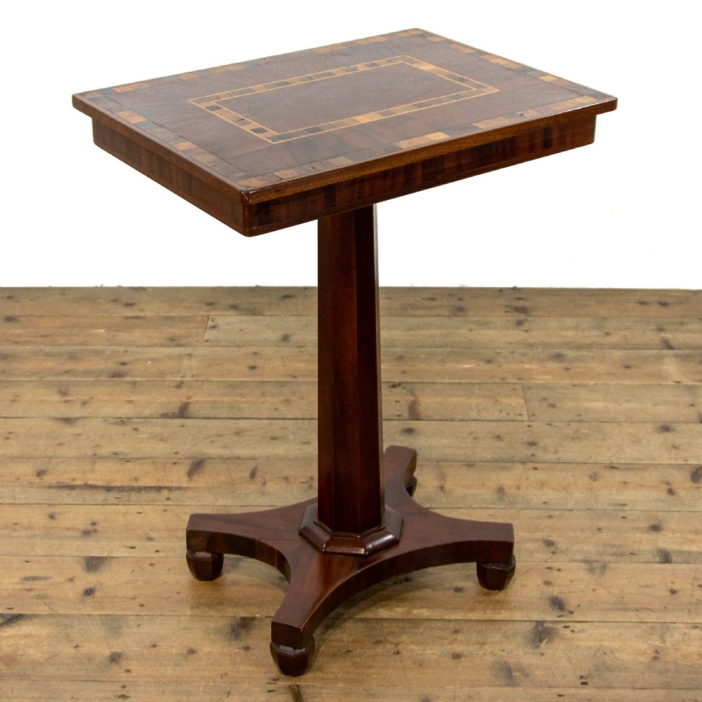 A dark brown mahogany side table featuring a rectangular top with geometric timber inlay, a central octagonal column, and a four-pointed pedestal base.