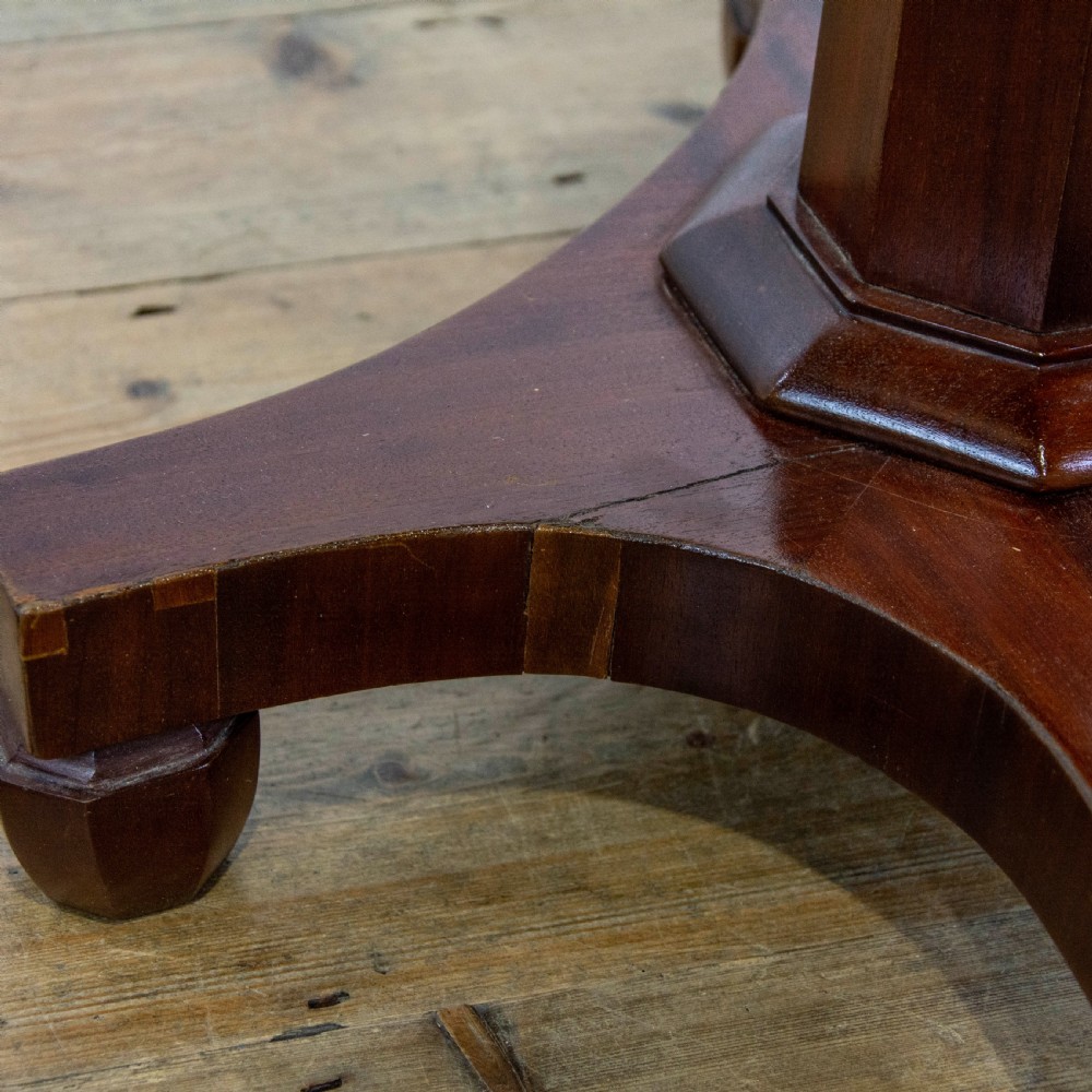 A dark brown mahogany side table featuring a rectangular top with geometric timber inlay, a central octagonal column, and a four-pointed pedestal base. View VII