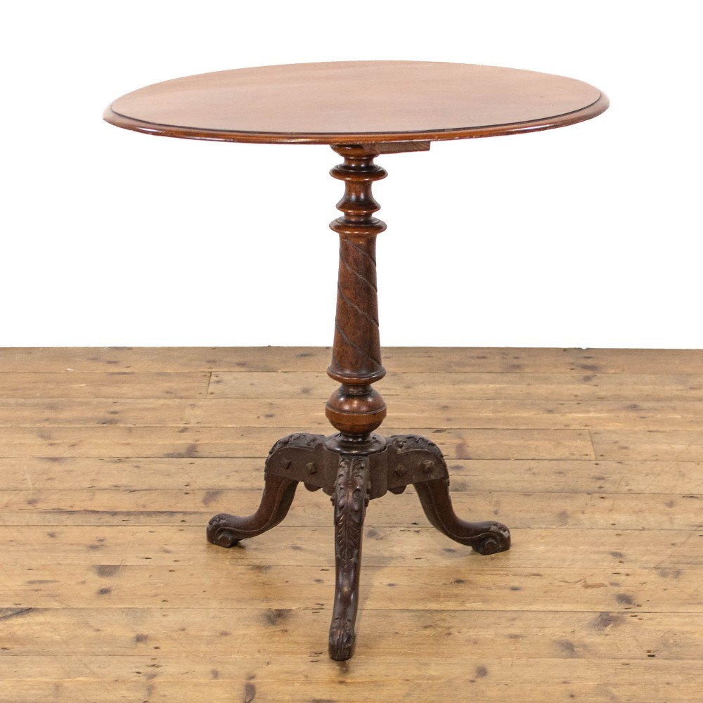 A Victorian mahogany tripod wine table featuring a round top, a spiral-turned central pedestal, and three carved legs.