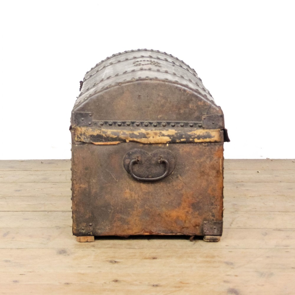 An antique dark brown leather domed trunk decorated with metal studs and initials on the curved lid. View IV
