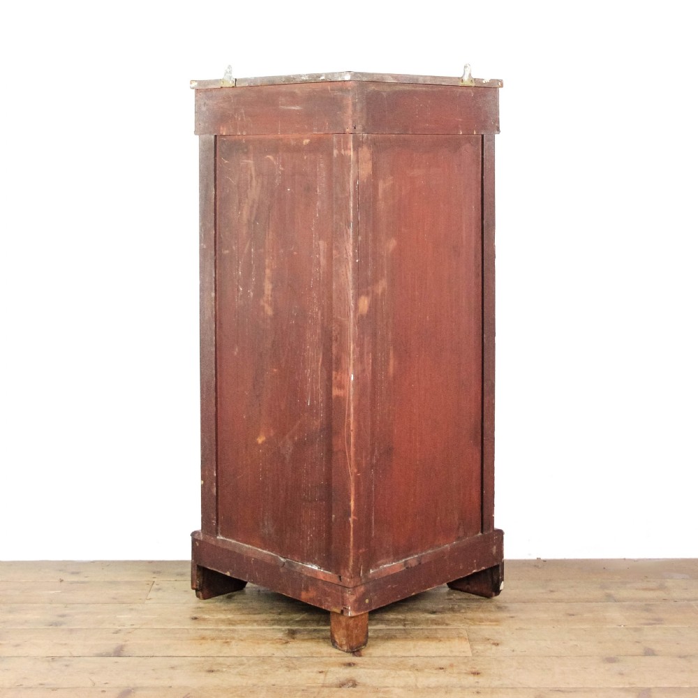 A Victorian bow front corner cupboard made of polished walnut wood, featuring floral marquetry inlay on the top frieze, gilt bronze corner mounts, and a glass-fronted door revealing a fabric-lined interior. View X