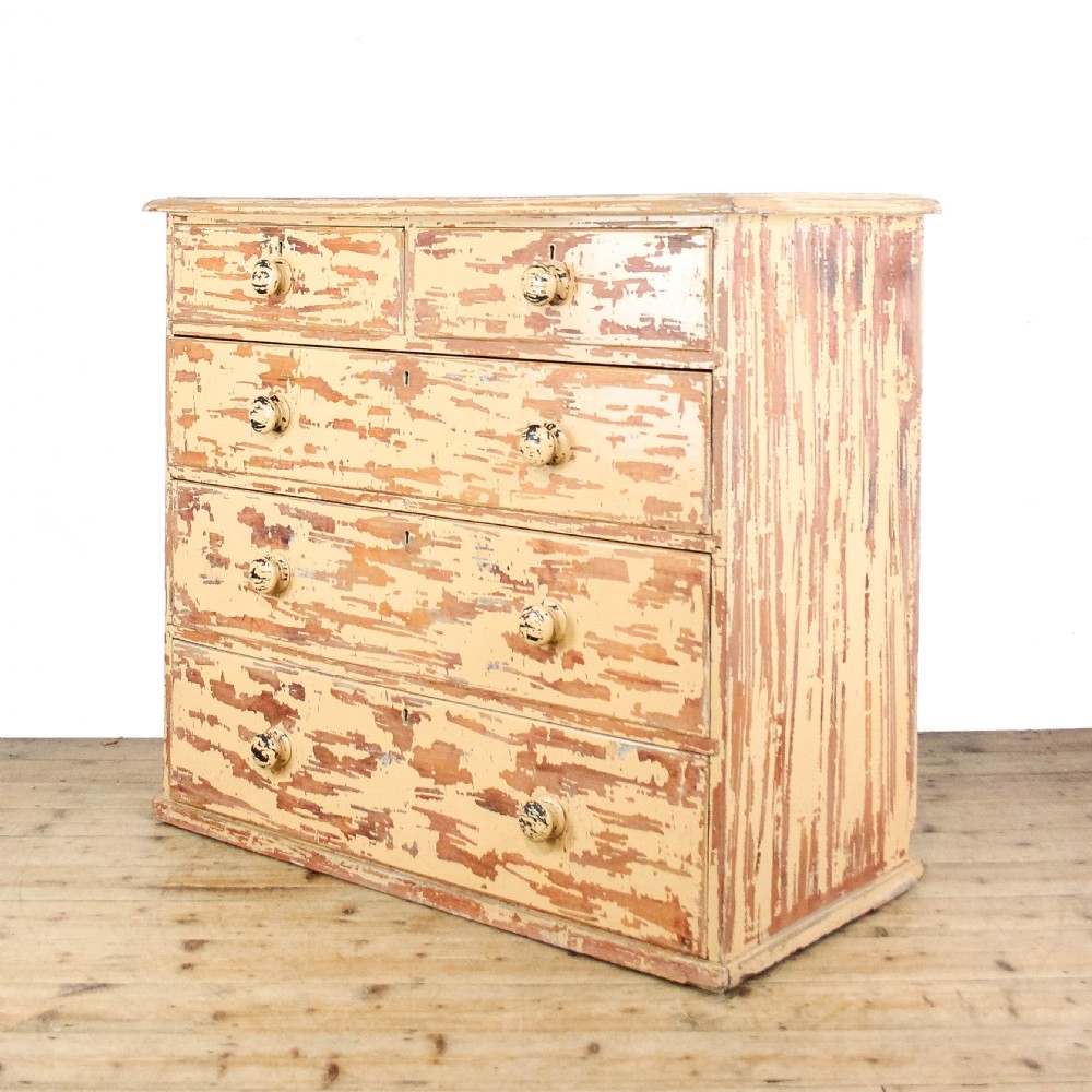 An antique Victorian painted pine chest of drawers featuring two short over three long drawers with turned wooden knobs and a heavily distressed cream paint finish. View II