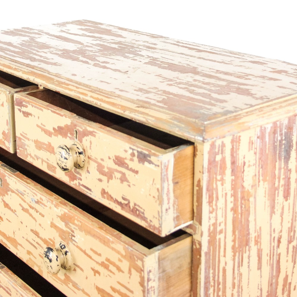 An antique Victorian painted pine chest of drawers featuring two short over three long drawers with turned wooden knobs and a heavily distressed cream paint finish. View III