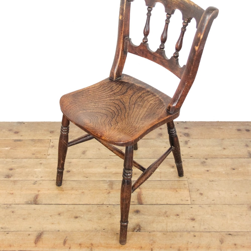A set of three Victorian elm farmhouse dining chairs featuring shaped seats, turned spindles, and dark timber finishes. View V