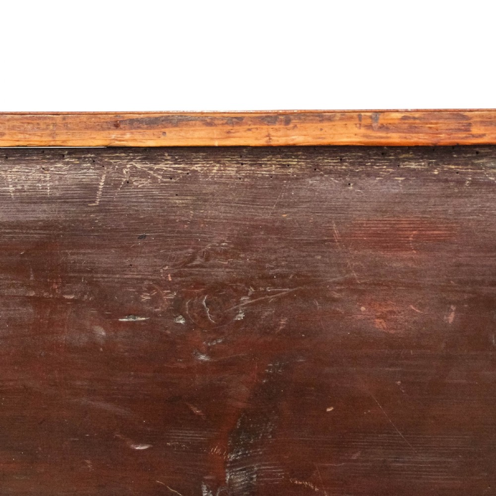 A Georgian mahogany side table featuring three drawers with brass ring handles, chevron timber veneer, and four square tapered legs. View V
