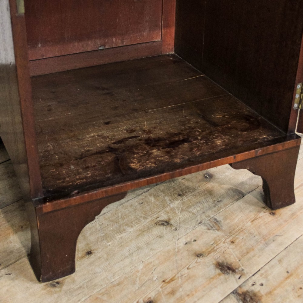 A pair of matching 19th-century mahogany side cabinets with flame mahogany door panels, single upper drawers, and shaped bracket feet. View IV