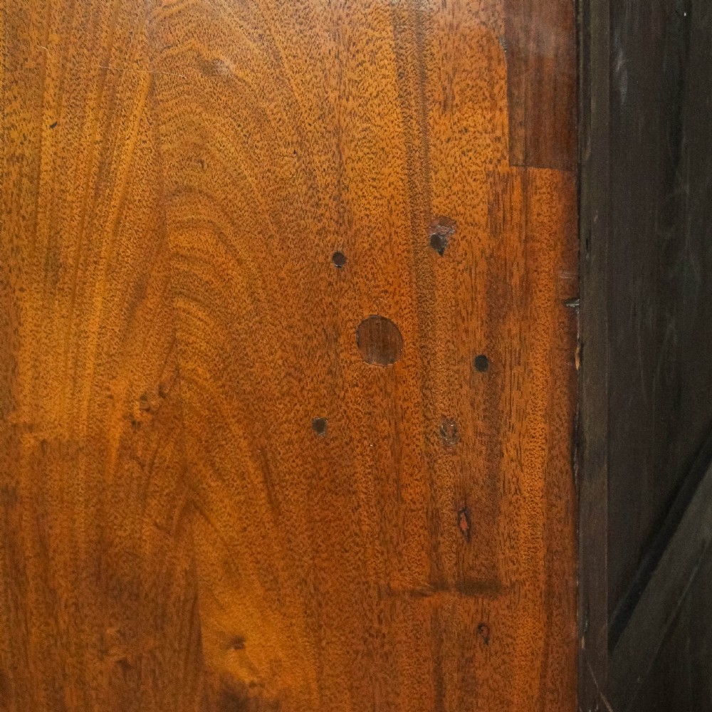 A pair of matching 19th-century mahogany side cabinets with flame mahogany door panels, single upper drawers, and shaped bracket feet. View VII