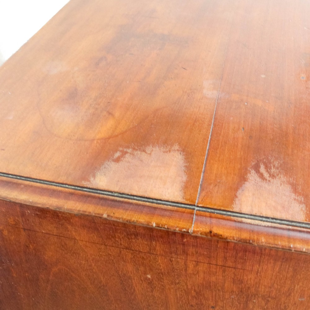 A 19th-century mahogany chest of drawers featuring three small top drawers above three long lower drawers with brass handles and bracket feet. View III