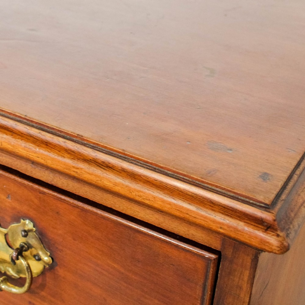 A 19th-century mahogany chest of drawers featuring three small top drawers above three long lower drawers with brass handles and bracket feet. View IX