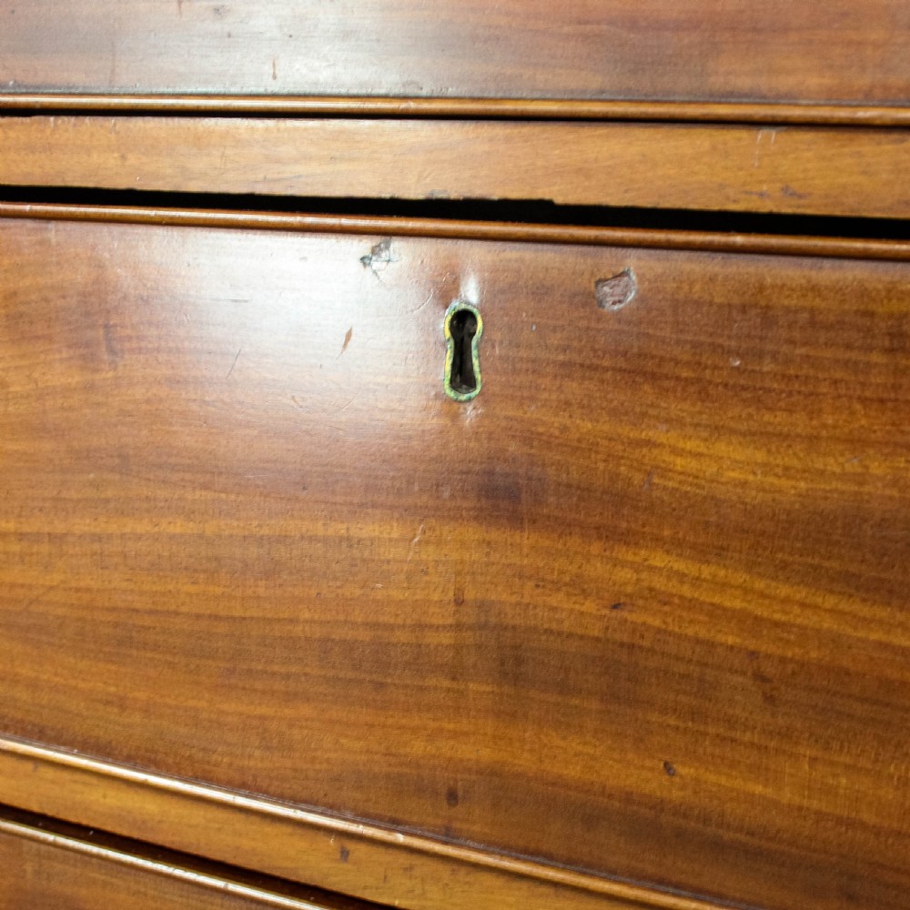 A 19th-century mahogany chest of drawers featuring three small top drawers above three long lower drawers with brass handles and bracket feet. View XI