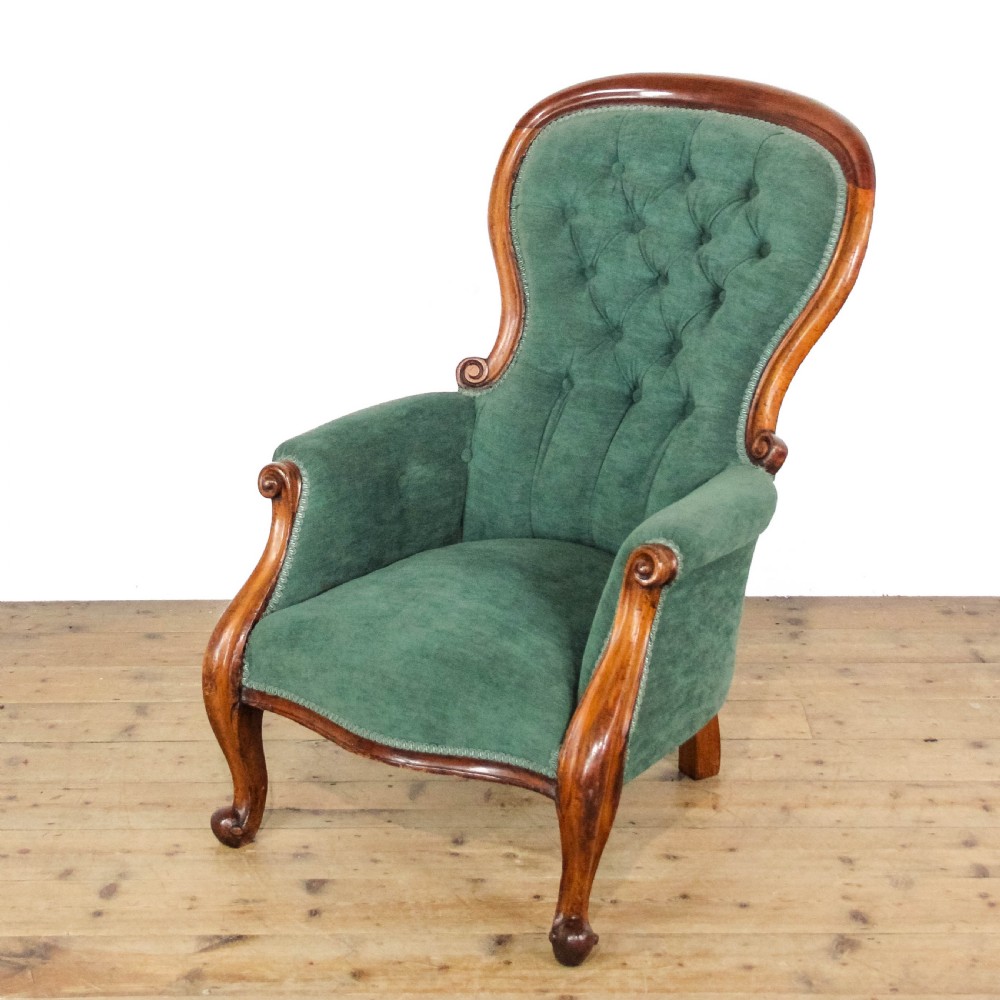 A Victorian upholstered armchair featuring deep buttoned green fabric, a contoured spoon back, and a polished mahogany frame with cabriole legs. View II