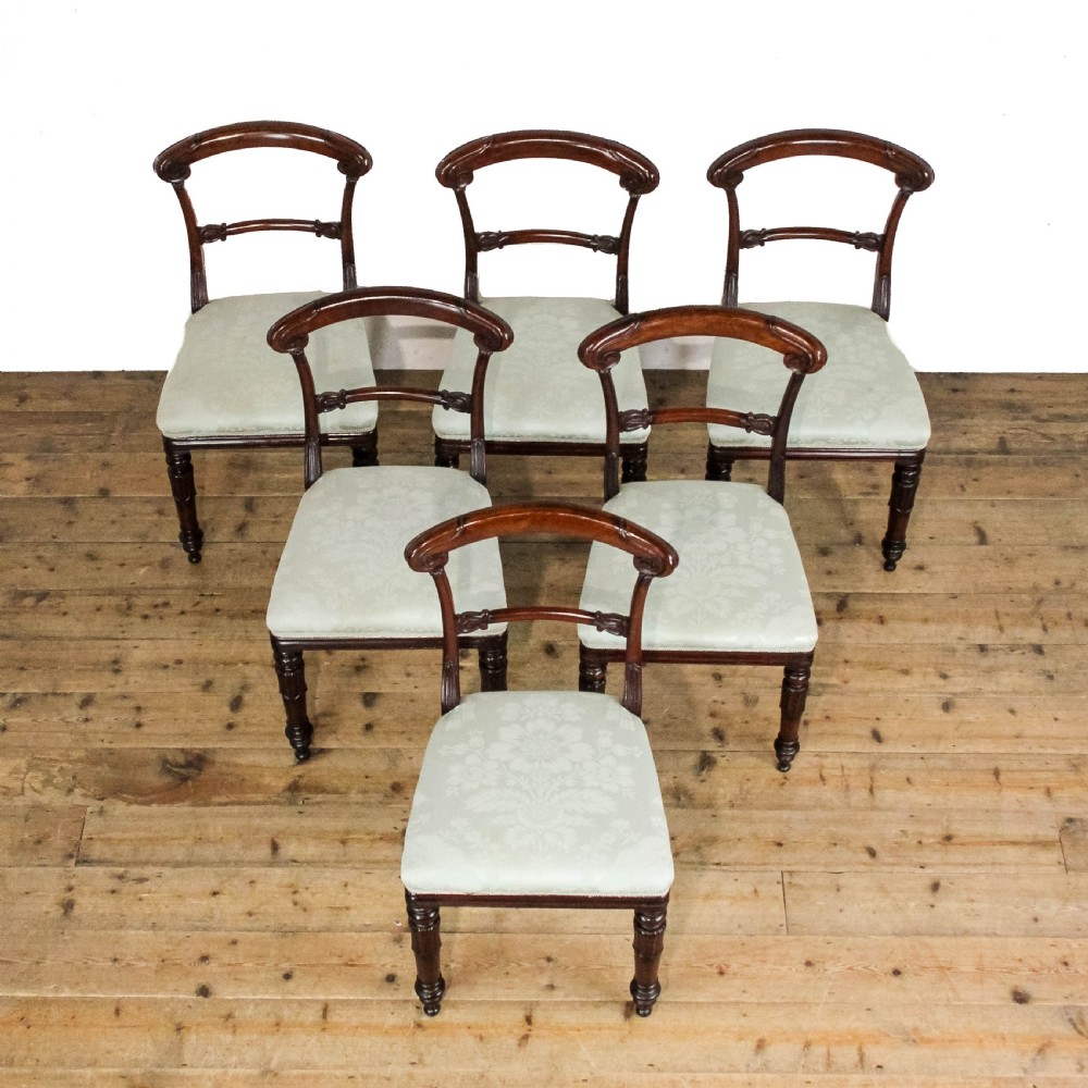 A set of six Victorian mahogany dining chairs with carved scroll backrests and pale green fabric seats. View II