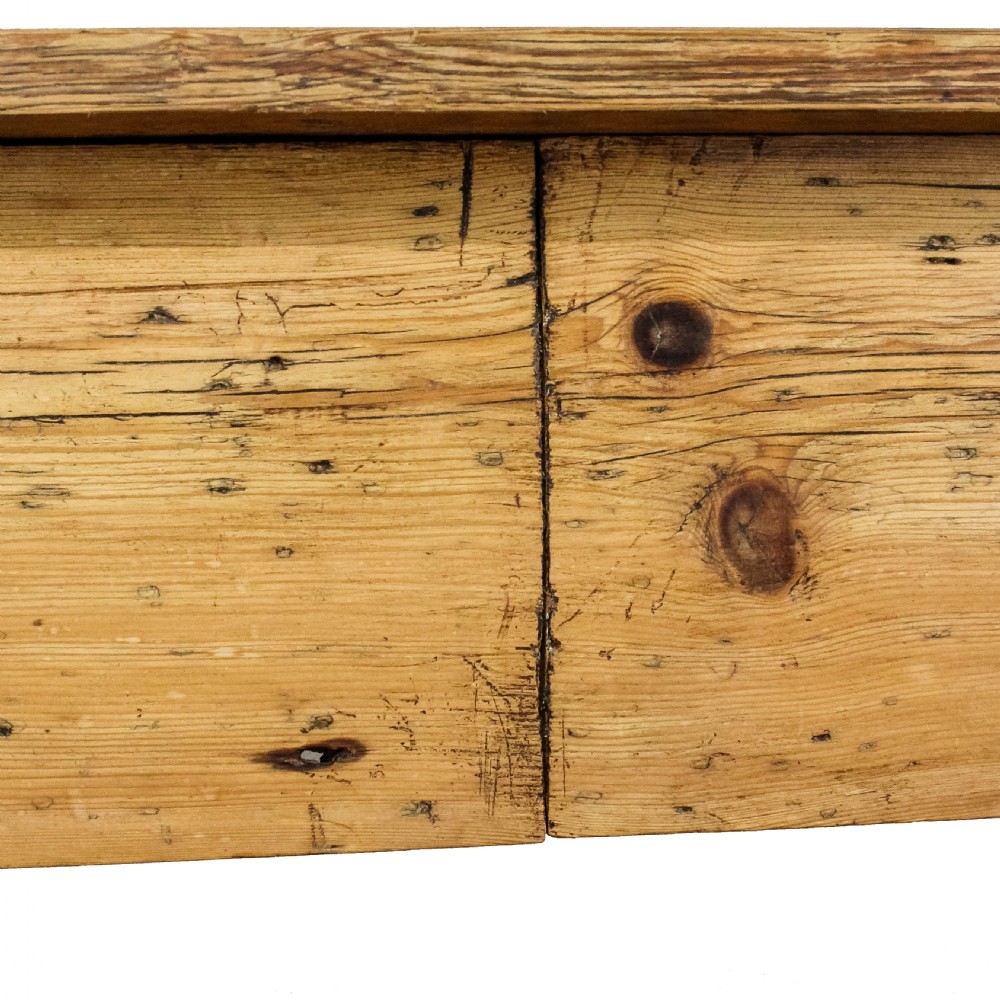 A large antique pine farmhouse kitchen table featuring a plank top, turned legs, and a single frieze drawer with a wooden knob. View VI