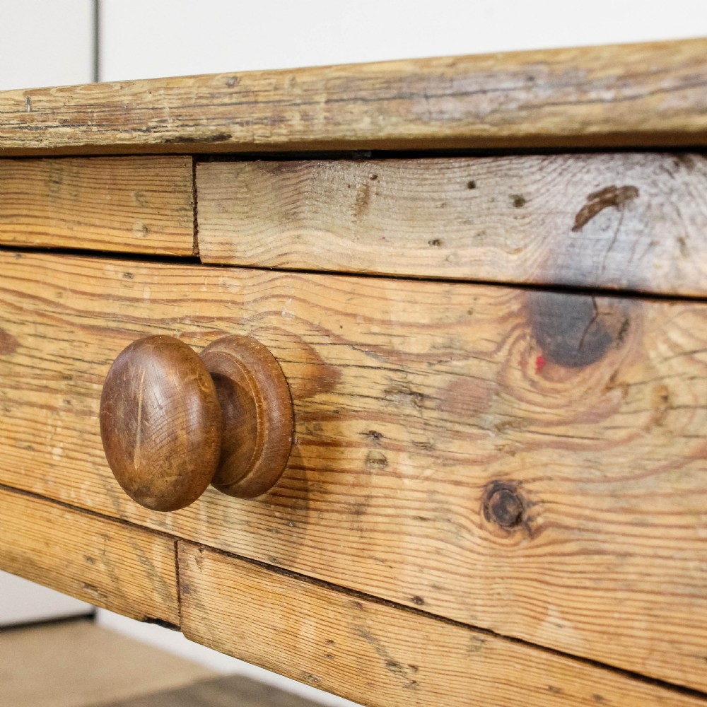 A large antique pine farmhouse kitchen table featuring a plank top, turned legs, and a single frieze drawer with a wooden knob. View XIV