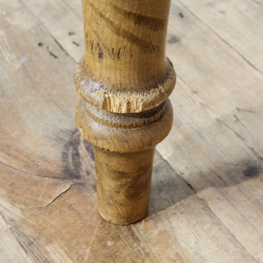 A large antique pine farmhouse kitchen table featuring a plank top, turned legs, and a single frieze drawer with a wooden knob. View XV