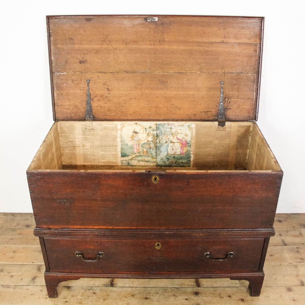 A nineteenth-century dark brown oak coffer on stand featuring a hinged top lid, a single lower drawer with brass handles, and bracket feet. View VIII