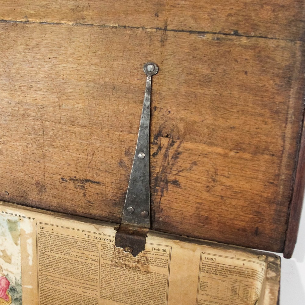 A nineteenth-century dark brown oak coffer on stand featuring a hinged top lid, a single lower drawer with brass handles, and bracket feet. View IX