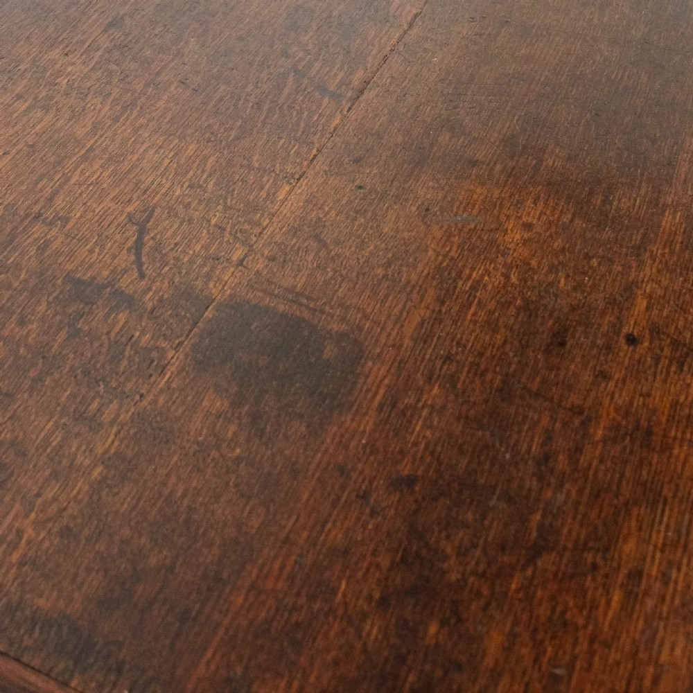 A nineteenth-century dark brown oak coffer on stand featuring a hinged top lid, a single lower drawer with brass handles, and bracket feet. View XIII