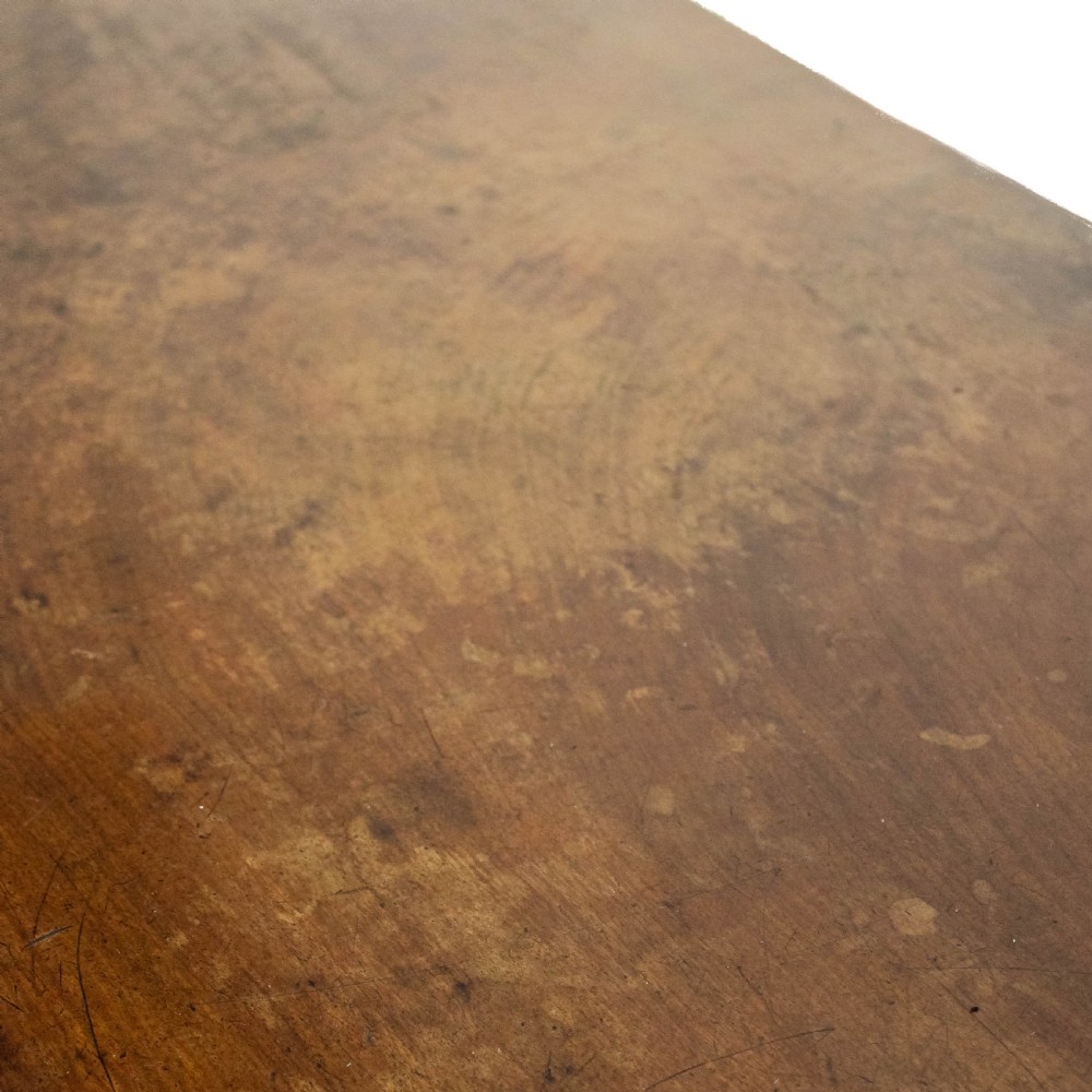 A 19th-century mahogany lowboy side table featuring three drawers with brass handles and a shaped apron set on four straight legs. View III