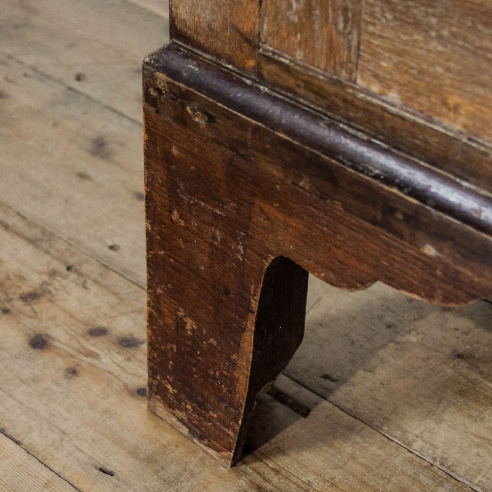 A 19th-century oak linen press featuring two top panelled doors, three central drawers, and a lower double-door cupboard on bracket feet. View XI