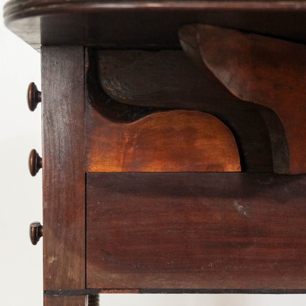 A Victorian mahogany Pembroke worktable featuring two drop leaves, three stacked drawers with turned wood knobs, ring-turned legs, and fitted brass castors. View XIII
